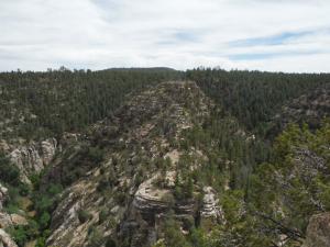 The main cliff dwellings are built into a tall hill surrounded by water which is called an island